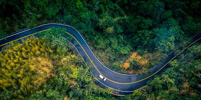 Car driving on long road